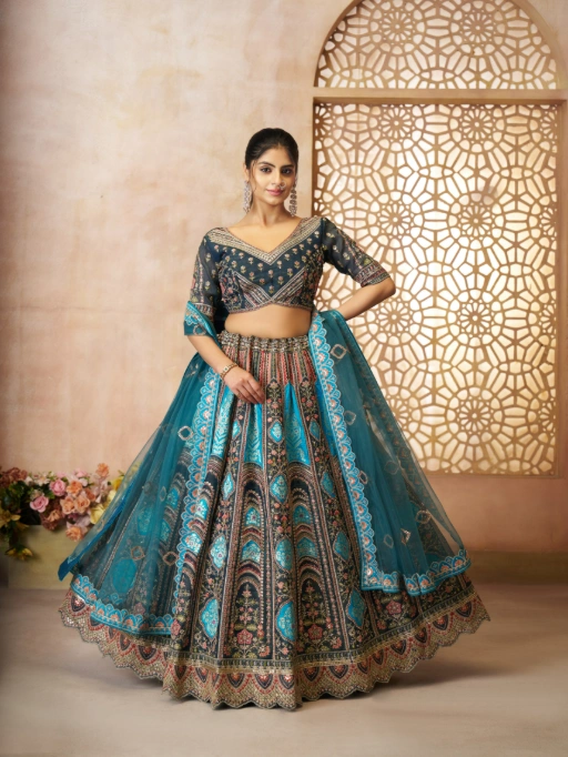 Buy Vardan 31 Pink Aari Embroidered Banarasi Lehenga for Wedding online at the best price. This exquisite wedding lehenga is designed with intricate Aari embroidery and delicate floral motifs. The rich Banarasi silk fabric and regal patchwork add a touch of heritage and sophistication, making it the perfect choice for a wedding celebration.